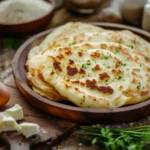 Stack of pancakes made without milk, eggs, or butter on rustic plate