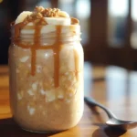 Jar of protein overnight oats with banana and peanut butter topping