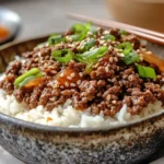 A bowl of Korean ground beef with rice and green onions