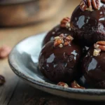 Stack of pecan pie brownie bombs on ceramic plate